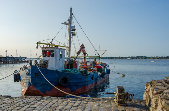 a tug boat anchored at a harbor, no person