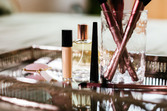 Cosmetic products and perfume on tray