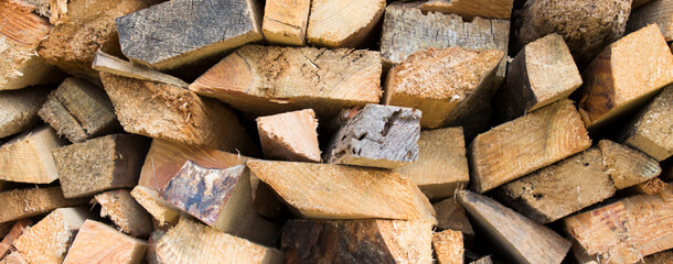 Wall firewood. Background of dry chopped firewood logs in a pile