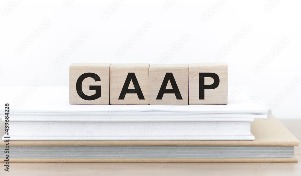 Poster generally accepted accounting practice. gaap the word on wooden cubes on a stack of books on the tab