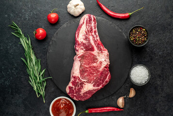 raw cowboy beef steak on stone background