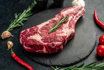 raw cowboy beef steak on stone background