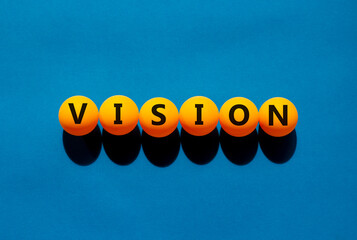 Vision and business symbol. The concept word 'vision' on orange table tennis balls on a beautiful...