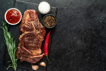 grilled cowboy beef steak on stone background with copy space for your text