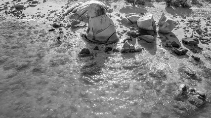 Drone Aerial Of Rock Formation On Stony Beach