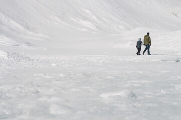 Father and Son Walking in Cold Snowy Landsacpe