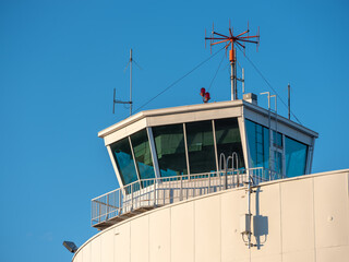 An exterior of an old and abandoned air traffic control tower from the 1930s'. VHF radio antennas...
