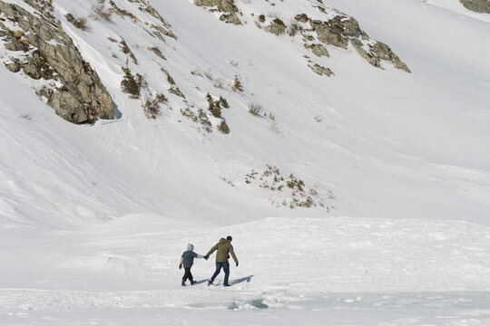Dad and Son hiking in Winter Landscape Outdoors