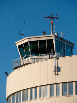 An exterior of an old and abandoned air traffic control tower from the 1930s'. VHF radio antennas on top of the roof.