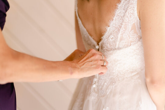 fastening bride's dress
