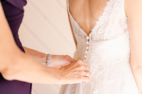 fastening bride's dress