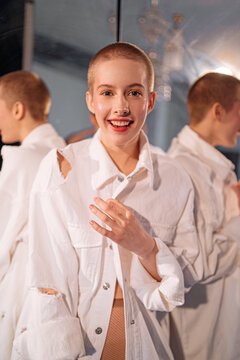 Cheerful young bald woman in fashionable shirt