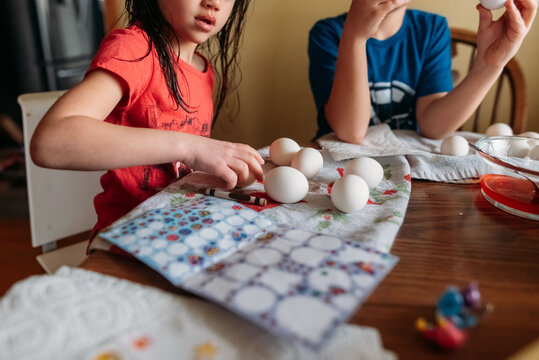 Family decorating Easter eggs together. 