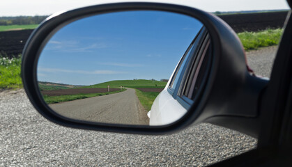 the road leading into the distance clouds and fields