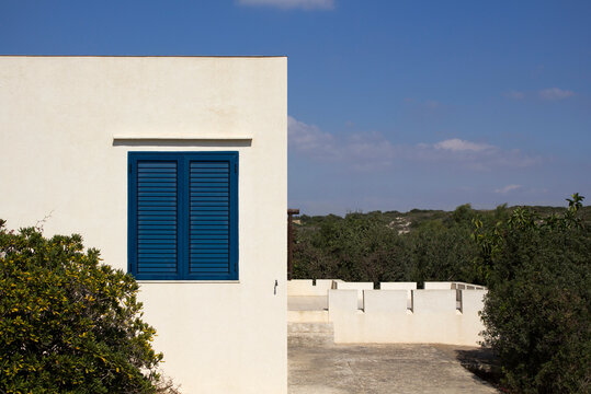 house with blue window shutter