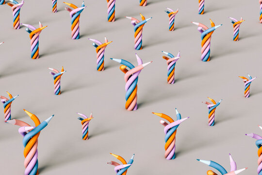 Twisted colorful pencils on grey background