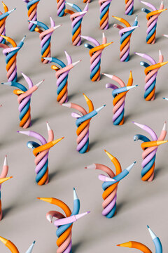 Twisted colorful pencils on grey background