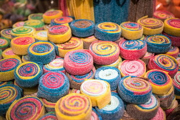 Sweet gummy multicolored marmalade on a display in shop