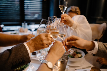 friends clink glasses of wine