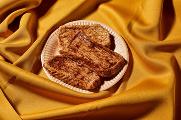 typical spanish torrijas in a paper plate