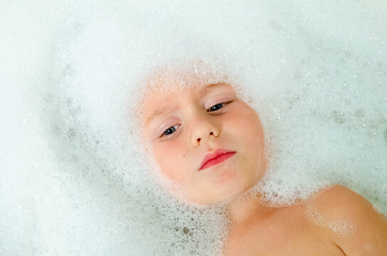 Young boy with bubbles in a bath