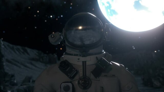 Astronaut stands on the surface of the moon among craters against the backdrop of the planet earth. Space exploration concept