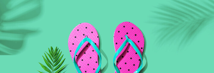 Flip flops with palm leaf shadow