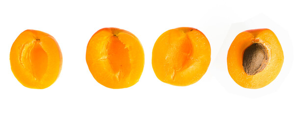 Four separate halves of a ripe apricot fruit, on a white background, isolated