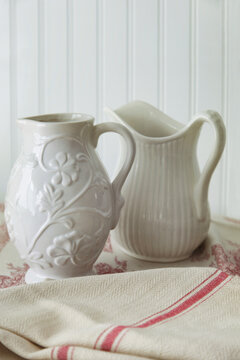 Closeup of old pitchers on table