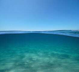 Blue sky with sand underwater sea, split view over and under water surface, Mediterranean sea