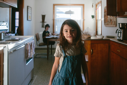 Portrait of girl in backlit kitchen