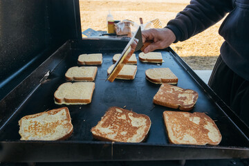 Flipping french toast on the grill. 
