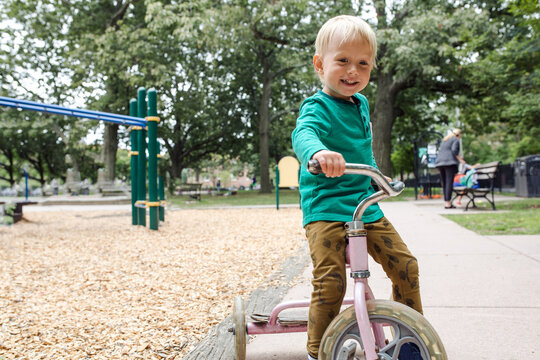 Little boy riding a tricycle