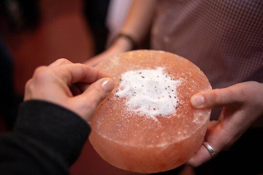 Closeup of woman sampling artisanal salt.