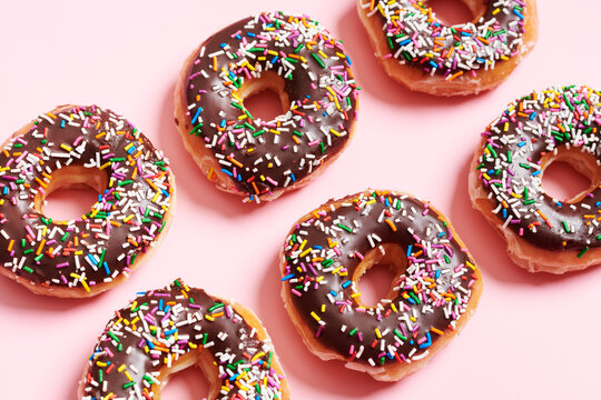 Choclolate Sprinkle Donuts on Pink Background 