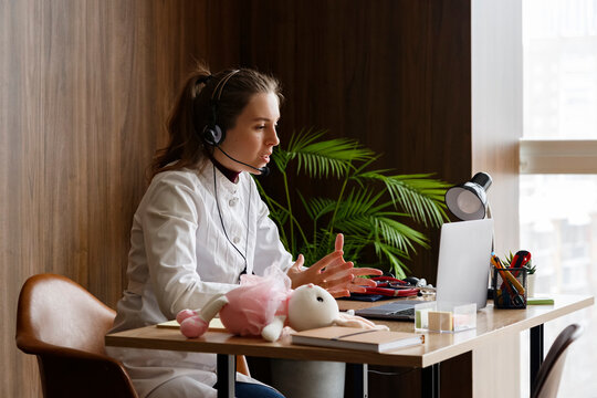 Doctor in uniform talking on video chat during remote work