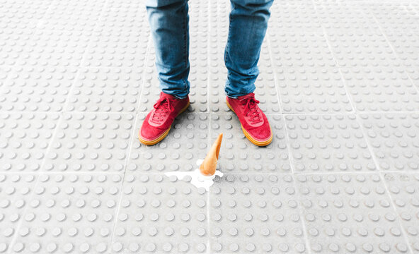 Male feet with ice cream in the ground