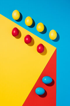 Easter eggs laid out in an abstract design on the colourful background 