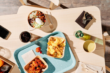 Various delicious Mexican fast food on wooden table