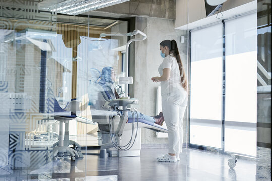 Woman connecting with dentist during planned appointment 