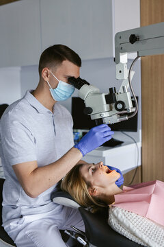 Specialist using microscope for dental scrutiny 