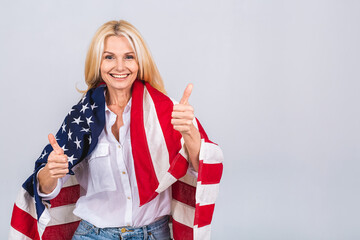 Smiling senior beautiful patriotic woman wearing united states flag isolated over white background...