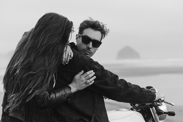 Trendy Couple with Motorcycle on Beach