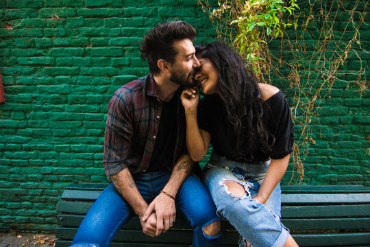 Man kissing is girlfriend nose and making her giggle