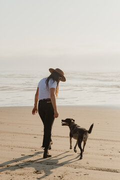 Woman with dog on the beach