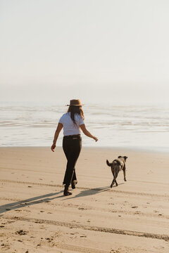 Woman with dog on the beach