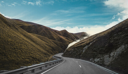 Twisty road with clouds