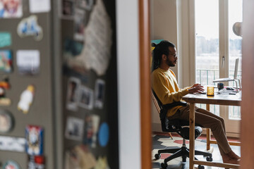 Young man at work on pc