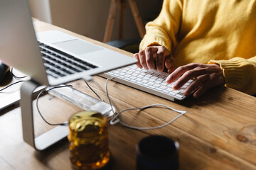 Hands typing on the computer keyboard