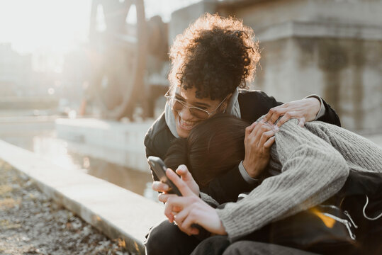 Two latin friends hugging.